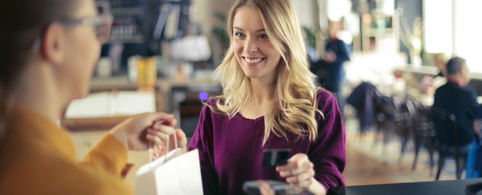 A woman pays for her good using a credit card