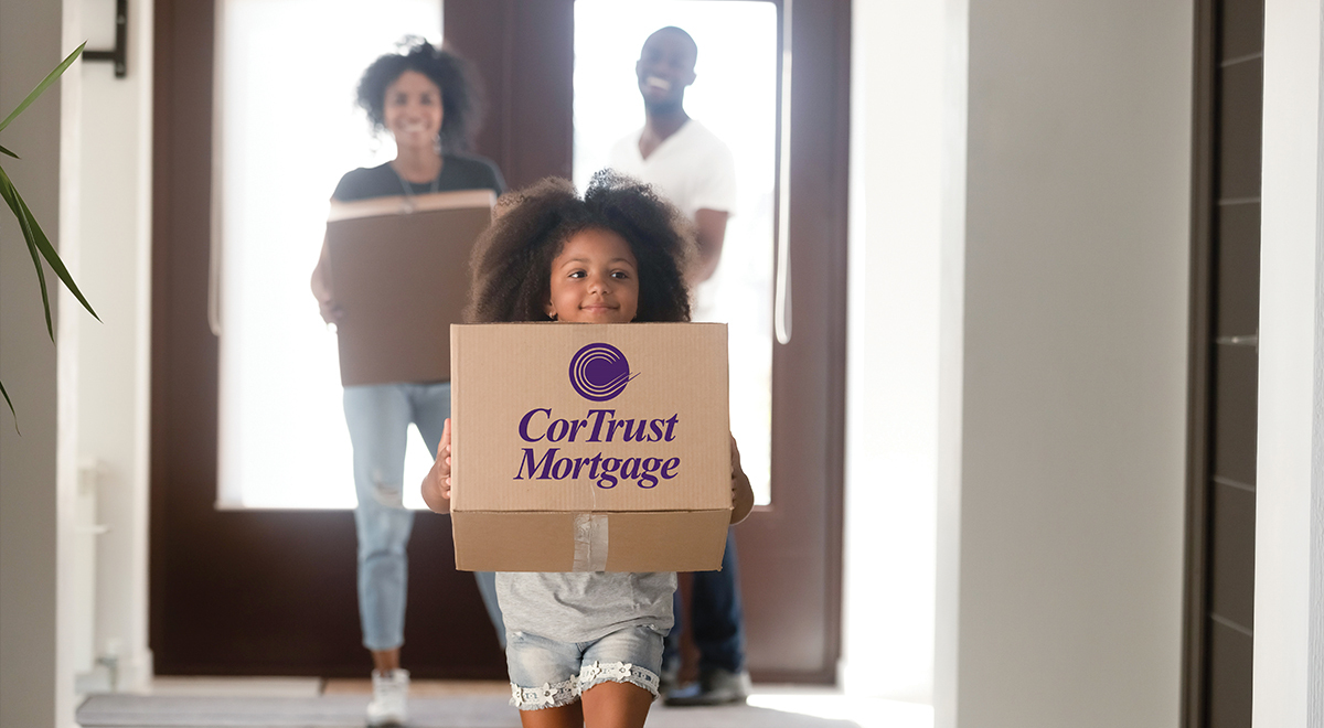 Child carrying a moving box onto a new home.