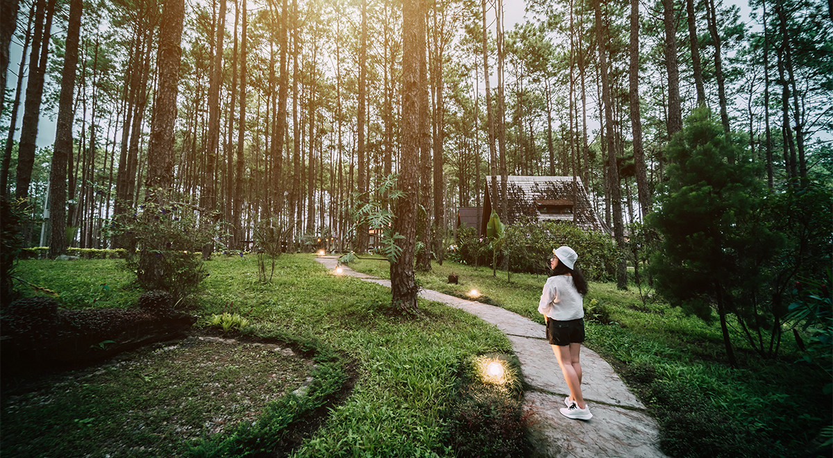 A woman walks along a path while on vacation